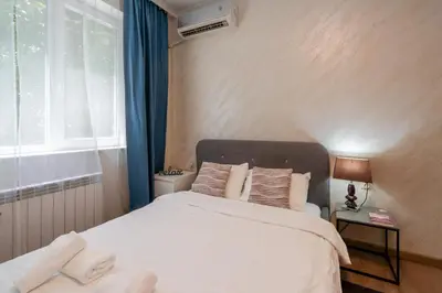 a bedroom with a large white bed with a window at Luminous 2BDR with Balcony & View in the center in Sofia