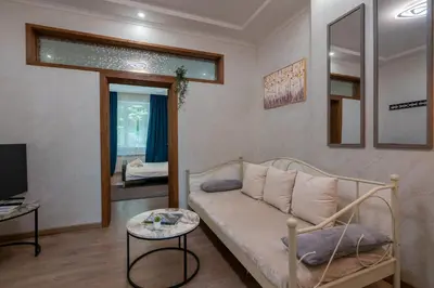 a living room with a couch and a tv at Luminous 2BDR with Balcony & View in the center in Sofia