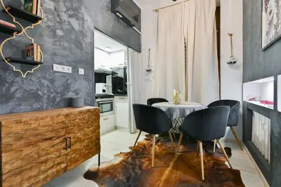 a kitchen and dining room with a table and chairs at Luxory in Sofia