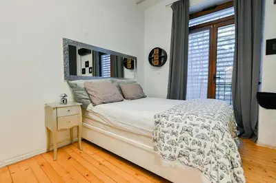 a white bedroom with a bed and a mirror at Luxory in Sofia