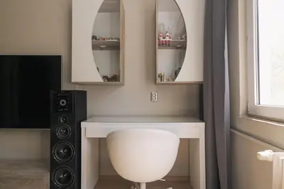 a bathroom with a sink and a mirror and a speaker at Iztok House Apartment in Sofia