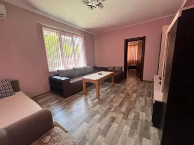 a living room with a couch and a table at Речен шепот in Kalofer