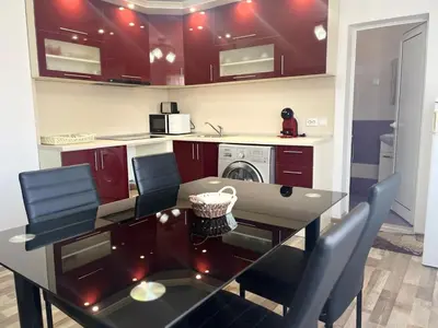 a kitchen with a dining room table with chairs at Речен шепот in Kalofer