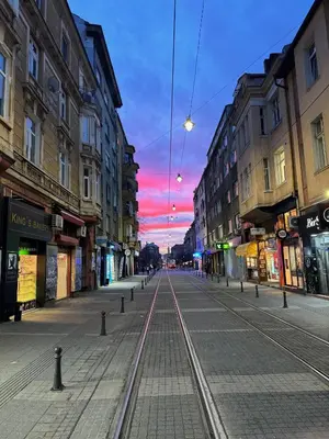 an empty street with train tracks in a city at The Executive Escape Sofia in Sofia