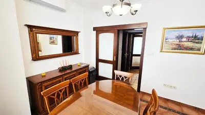 a dining room with a table and a mirror at The Executive Escape Sofia in Sofia