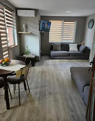 a living room with a couch and a table at Philipopolis Stay in Plovdiv