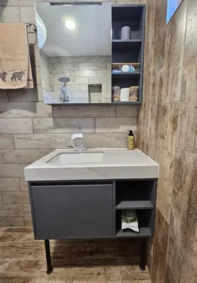 a bathroom with a sink and a mirror at Philipopolis Stay in Plovdiv