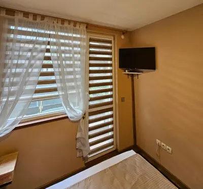 a room with a window and a flat screen tv at Philipopolis Stay in Plovdiv