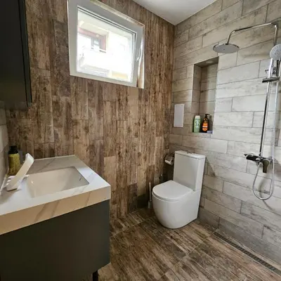 a bathroom with a toilet and a sink and a window at Philipopolis Stay in Plovdiv