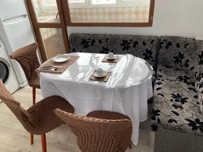 a table with a white table cloth on it with chairs at Панорама in Panagyurishte