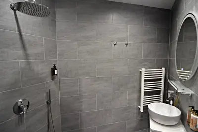 a bathroom with a shower and a toilet and a sink at Oblivion in Velingrad