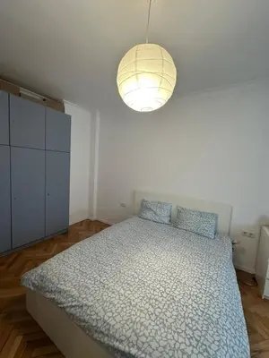 a bedroom with a bed and a light fixture at Apartament 151 in Sofia