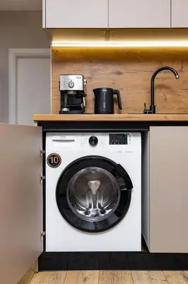 a washer and dryer under a counter in a kitchen at 1BR Modern and Cozy Apartment with Free Street Parking in Plovdiv