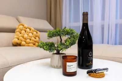 a bottle of wine sitting on a table next to a bottle of wine at 1BR Modern and Cozy Apartment with Free Street Parking in Plovdiv