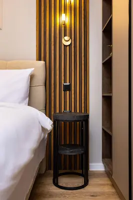 a side table next to a bed in a room at 1BR Modern and Cozy Apartment with Free Street Parking in Plovdiv