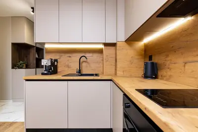 a kitchen with white cabinets and a sink at 1BR Modern and Cozy Apartment with Free Street Parking in Plovdiv