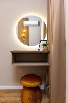 a stool in a room with a mirror at 1BR Modern and Cozy Apartment with Free Street Parking in Plovdiv