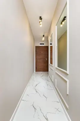 a hallway with marble flooring and a door at 1BR Modern and Cozy Apartment with Free Street Parking in Plovdiv