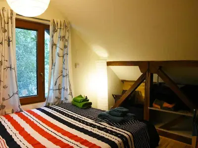 a bedroom with a bed with a striped blanket at Anna's downtown loft in Plovdiv