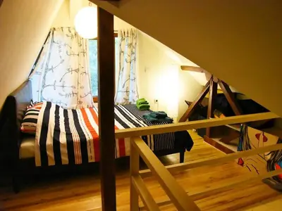 a small room with a bed in a attic at Anna's downtown loft in Plovdiv