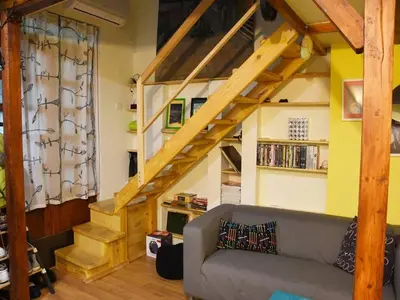 a living room with a staircase and a couch at Anna's downtown loft in Plovdiv