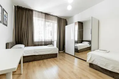 a bedroom with two beds and a mirror at Finest 3BR Downtown in Sofia