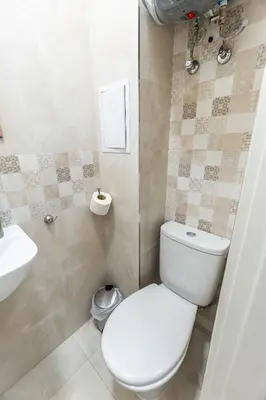 a bathroom with a toilet and a sink at Finest 3BR Downtown in Sofia