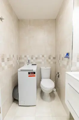 a small bathroom with a toilet and a sink at Finest 3BR Downtown in Sofia