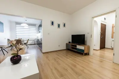 a living room with a television and a table at Finest 3BR Downtown in Sofia