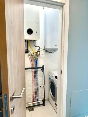 a laundry room with a washer and a washing machine at Апартамент В 48 в Сграда МОНА in Sofia