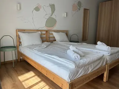 a bedroom with a bed with towels on it at Villa YoSi - apartments in Sapareva Banya