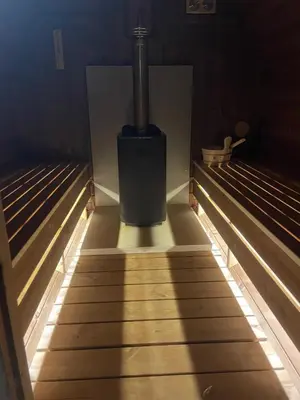 a room with two empty beds with a spotlight on the floor at Villa YoSi - apartments in Sapareva Banya