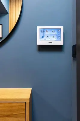 a wall with a tv on a blue wall at Stylish apt 'Photo Booth' with an amazing location in Plovdiv