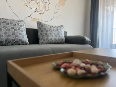 a plate of fruit on a table in a living room at Villa YoSi in Sapareva Banya