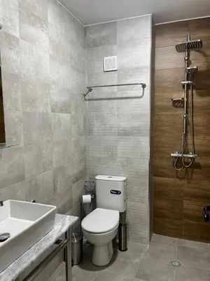 a bathroom with a toilet and a sink at Villa YoSi in Sapareva Banya