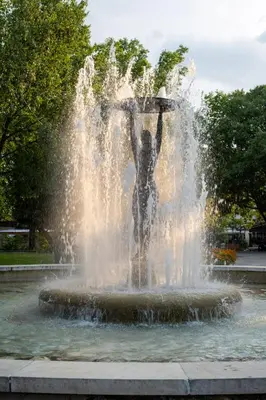 a statue of a man standing in a fountain at Студио 9 Парк Панорама in Hisarya