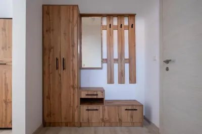 a room with a wooden cabinet and a mirror at Студио 9 Парк Панорама in Hisarya