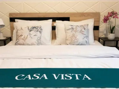a bed with a sign that says casa vista at Casa Vista - Spacious 2BR, 2Bath, Apartment in Sofia with 2 Free Parking in Sofia