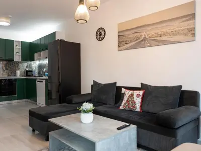 a living room with a couch and a table at Casa Vista - Spacious 2BR, 2Bath, Apartment in Sofia with 2 Free Parking in Sofia