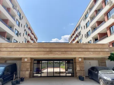 a garage with two cars parked in front of a building at Casa Vista - Spacious 2BR, 2Bath, Apartment in Sofia with 2 Free Parking in Sofia