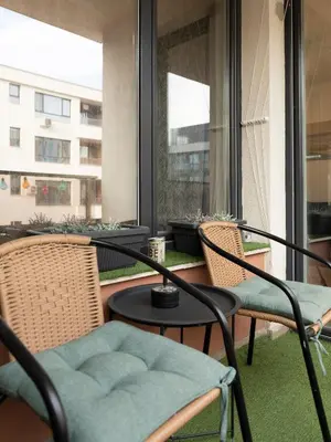 a balcony with two chairs and a table at Casa Vista - Spacious 2BR, 2Bath, Apartment in Sofia with 2 Free Parking in Sofia