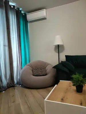 a living room with a chair and a table at Your Sweet Home in Sofia