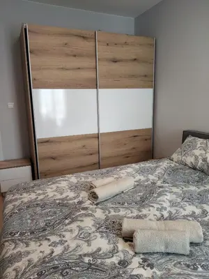 a bed with two towels sitting on top of it at Your Sweet Home in Sofia