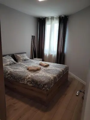 a bedroom with a bed with two towels on it at Your Sweet Home in Sofia