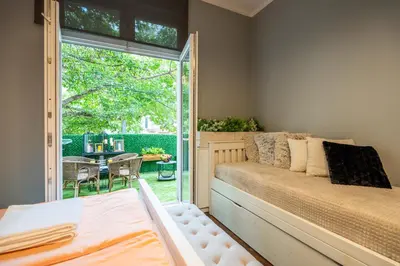a bedroom with a bed and a large window at VIP APARTMENT ViTOSHA 69 blvd 3 bdrm - TOP LOCATION in Sofia