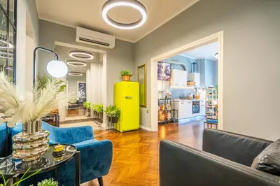 a living room with blue chairs and a yellow cabinet at VIP APARTMENT ViTOSHA 69 blvd 3 bdrm - TOP LOCATION in Sofia