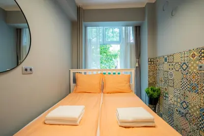 a bedroom with a bed with orange pillows and a window at VIP APARTMENT ViTOSHA 69 blvd 3 bdrm - TOP LOCATION in Sofia