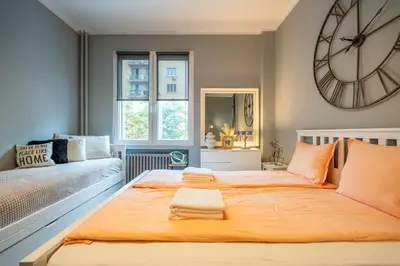 a bedroom with a large clock on the wall at VIP APARTMENT ViTOSHA 69 blvd 3 bdrm - TOP LOCATION in Sofia