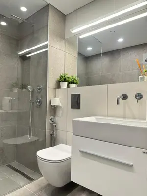 a bathroom with a toilet and a sink and a shower at Апартамент В 54 в Сграда МОНА in Sofia
