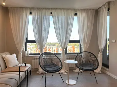 a living room with two chairs and a couch at Апартамент В 54 в Сграда МОНА in Sofia